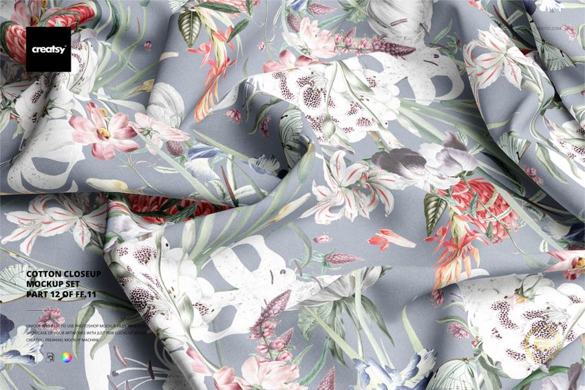 Detailed cotton fabric mockup showing draped material with multicolored botanical designs on a light blue surface.