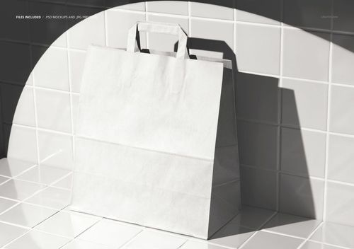 Standing blank fast food paper bag mockup on shiny white tiles with strong directional lighting and shadow effects.