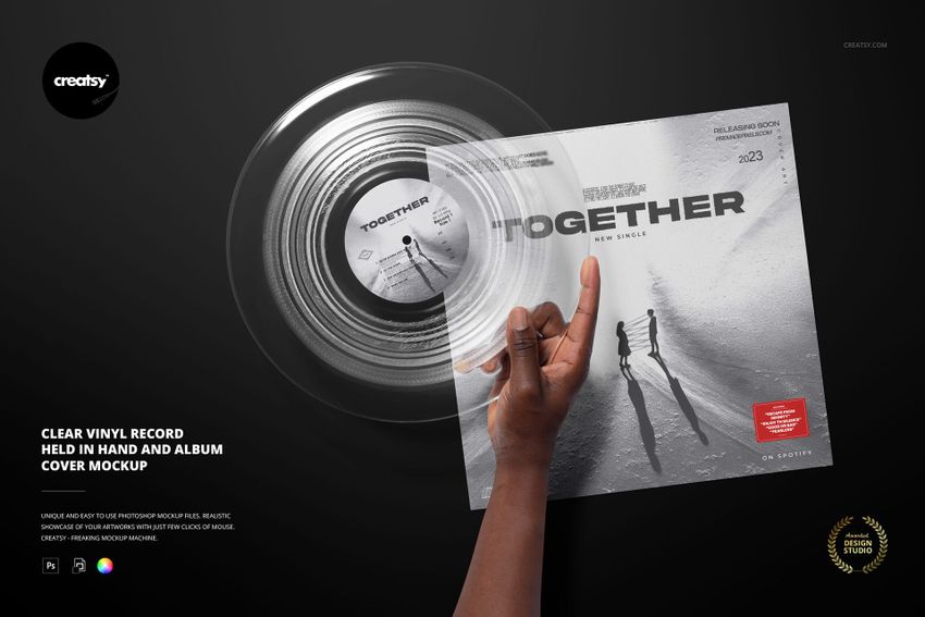 PSD mockup showing a clear vinyl record in hand with a stylish album cover, both placed against a dark scene.