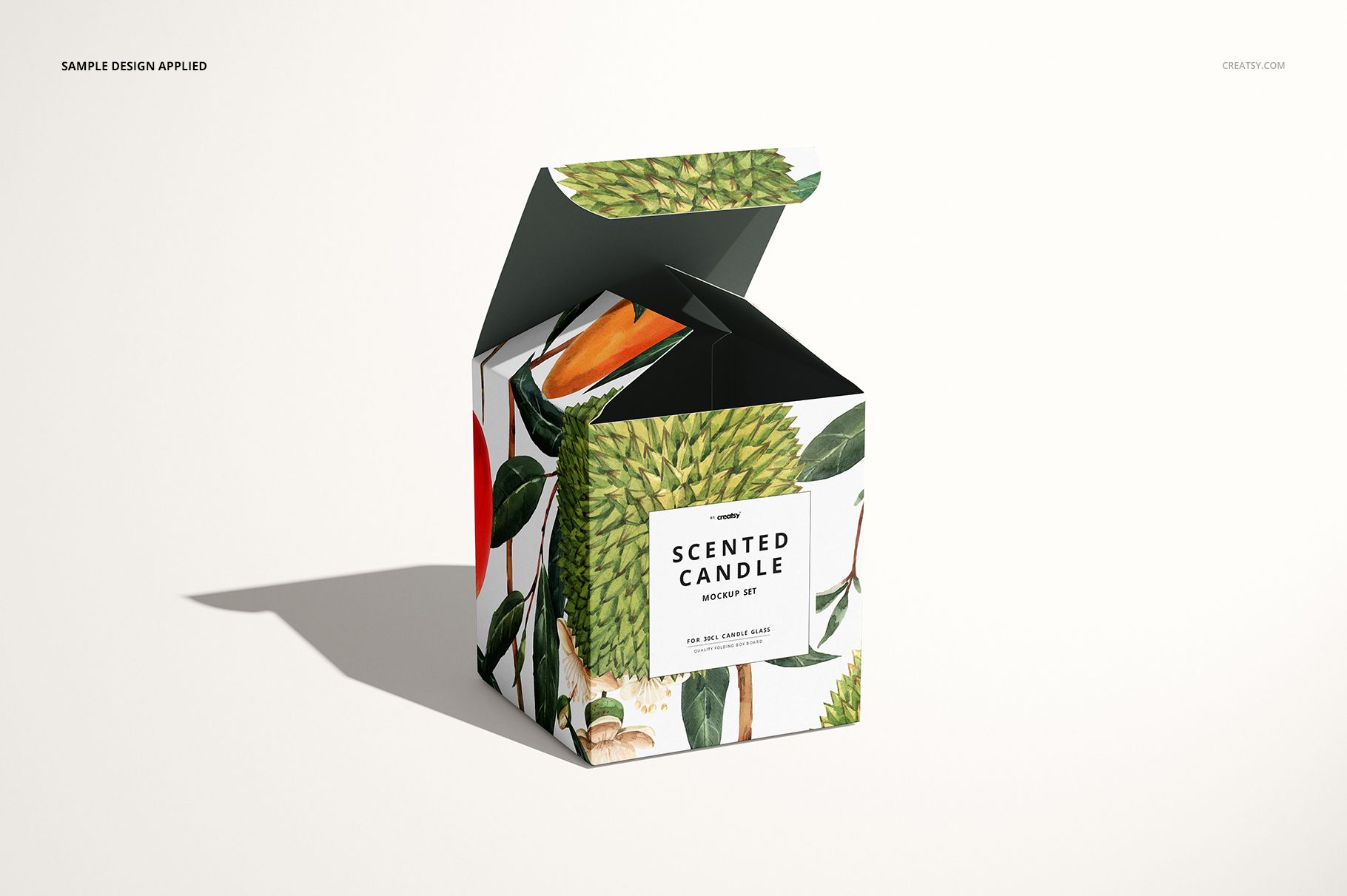Open 30cl candle box mockup with green leaf and orange flower design, shown on a light surface.