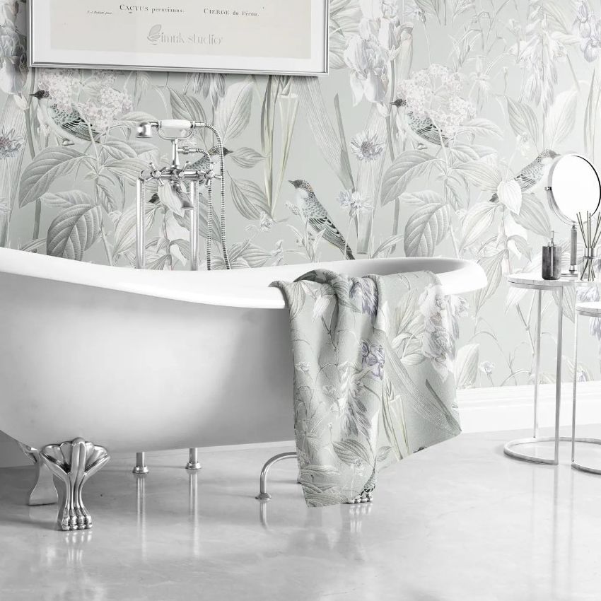 Victorian style bathroom mockup with a clawfoot bathtub, floral wallpaper, and a towel draped over the tub edge.
