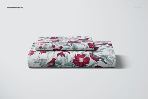 Front view of a folded bed sheet and pillow cover mockup featuring floral and bird motifs in red and green colors.