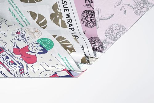 Assorted tissue paper mockup featuring colorful designs and botanical prints, shown from an angled top view.