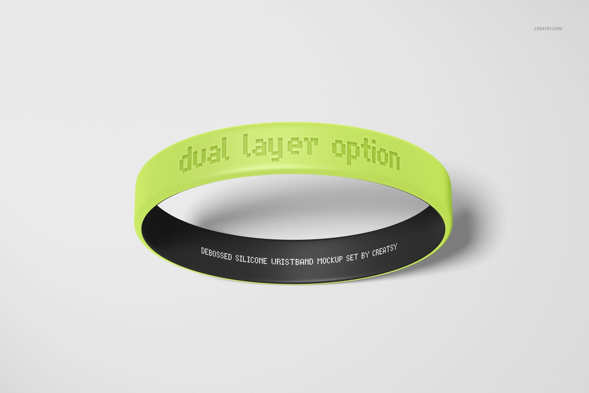 PSD mockup of a dual-layer silicone wristband featuring lime green exterior and black interior on a light background.