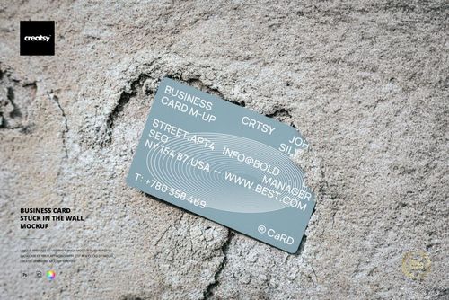 Rectangular business card with gray color and white text stuck in a textured concrete wall, front view mockup.