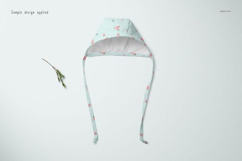Baby bonnet mockup displayed from top view, light blue fabric with small pink floral pattern and long straps.