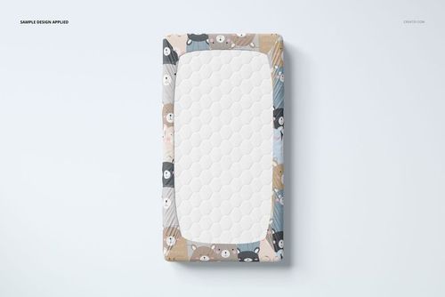 Top view of a crib sheet mockup featuring a white quilted center and colorful animal pattern border on a light background.