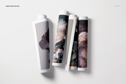 Rolled canvas print PSD mockup set showing floral artwork on each roll, arranged horizontally on a plain surface.