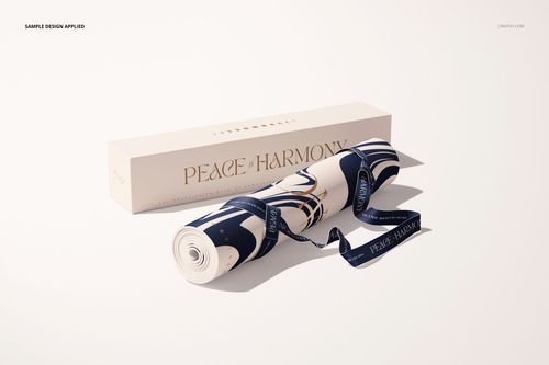 Yoga mat mockup featuring a rolled mat with geometric blue and cream design, next to a branded rectangular box.