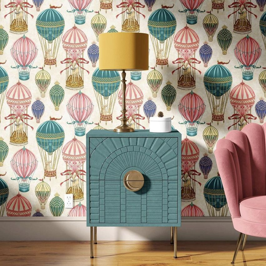 Drum lamp shade mockup displayed on a gold table lamp, set on a blue cabinet against a hot air balloon wallpaper.