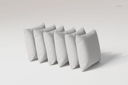 Front view of six white velvet cushions arranged in a row on a plain light background, showing soft texture.