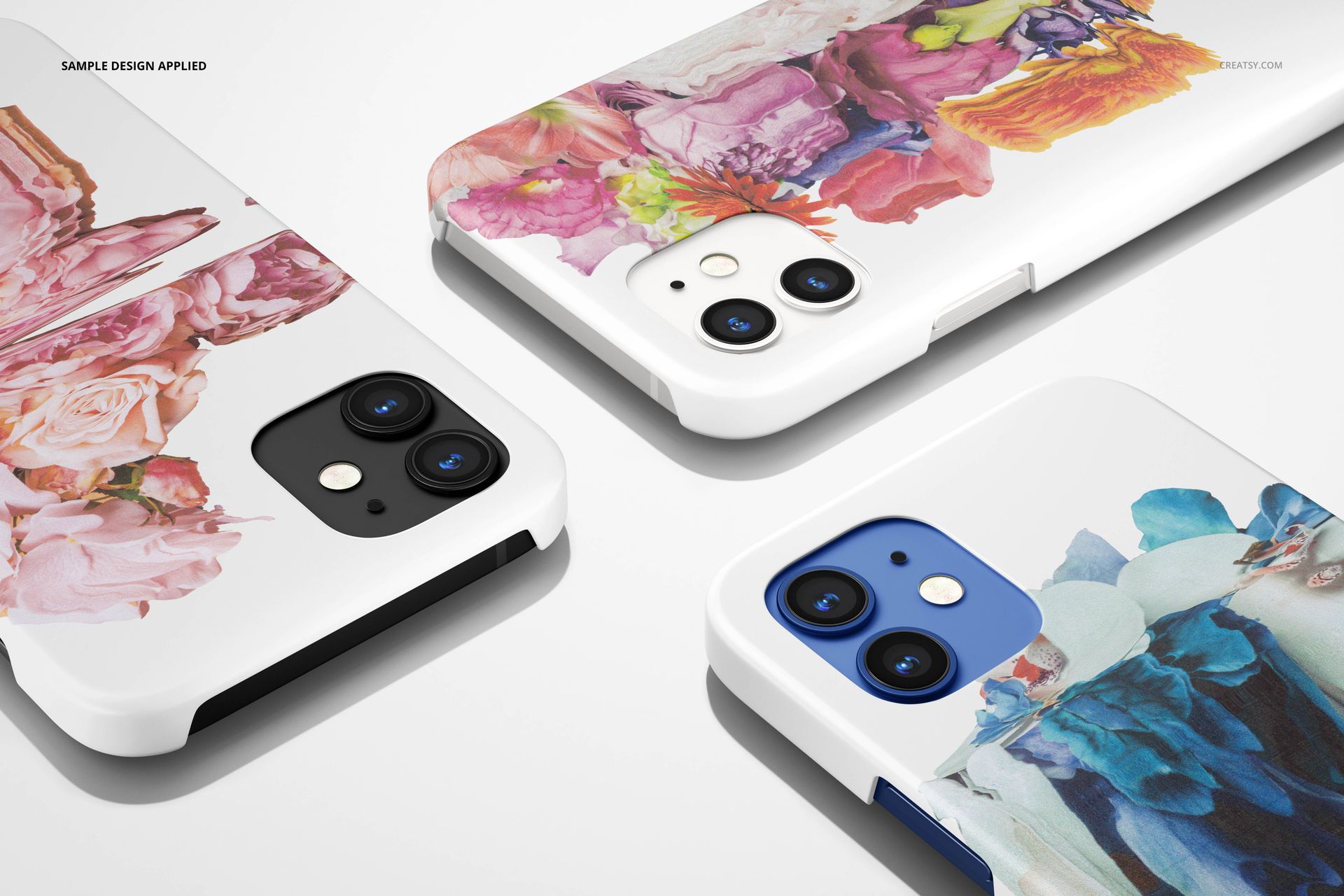 PSD mockup of iPhone 12 matte snap cases with artistic floral prints, arranged on a clean, light background.