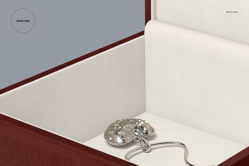 PSD mockup showing an open jewelry box with glossy wood frame, white padded interior, and a sparkling pendant necklace.