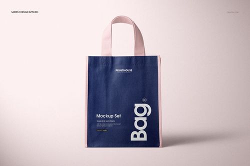 Non-woven tote bag mockup displayed upright, showing a navy blue front and light pink trim against a neutral backdrop.