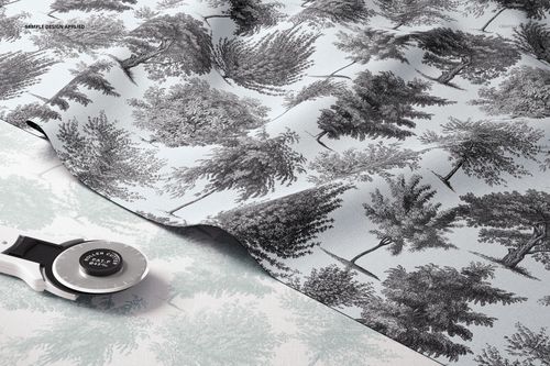 Layered fabric mockup featuring a black and white tree pattern on light blue textile, shown from a top angle.