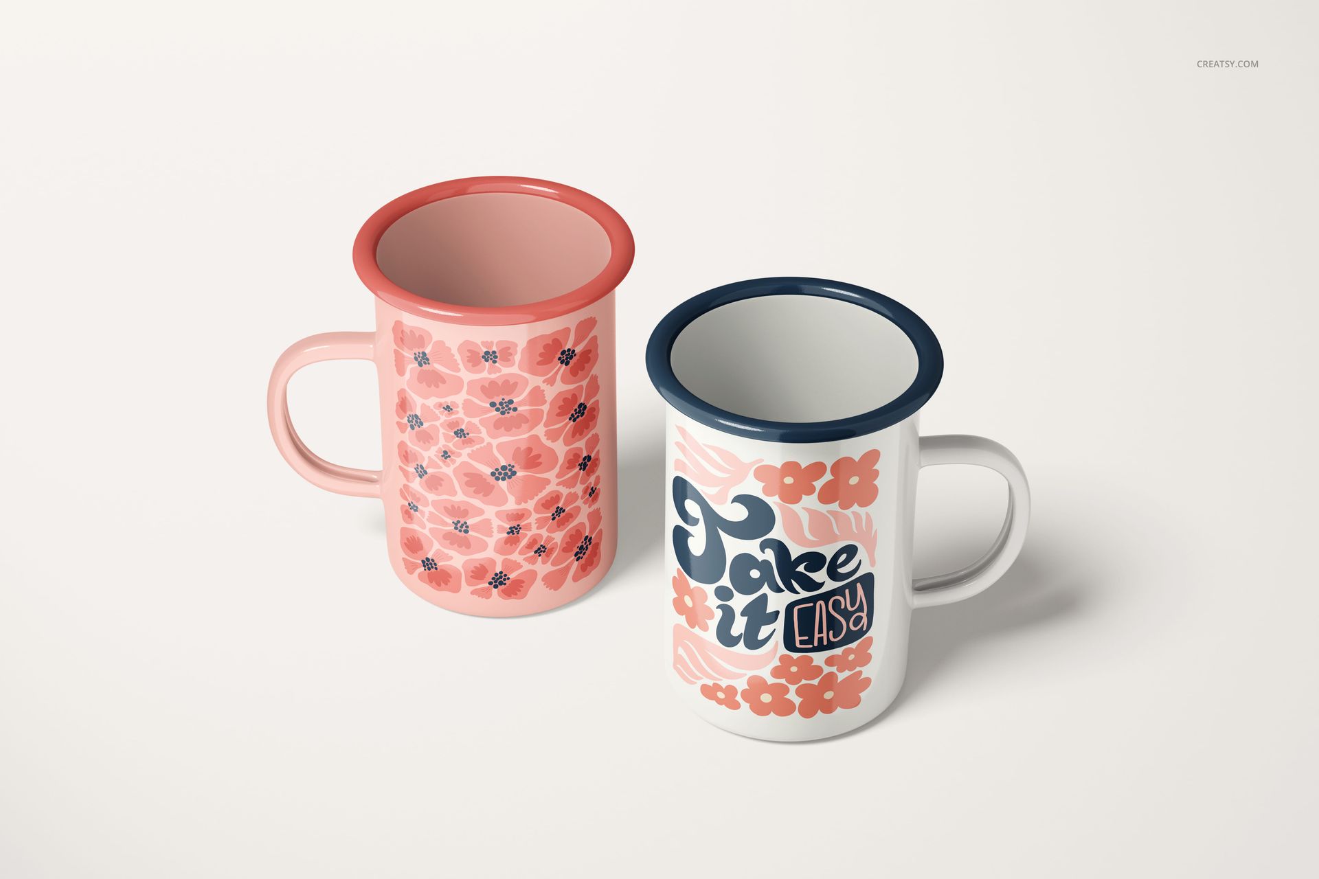 450ml enamel mugs mockup featuring a pink floral mug and a white mug with blue rim and decorative lettering.