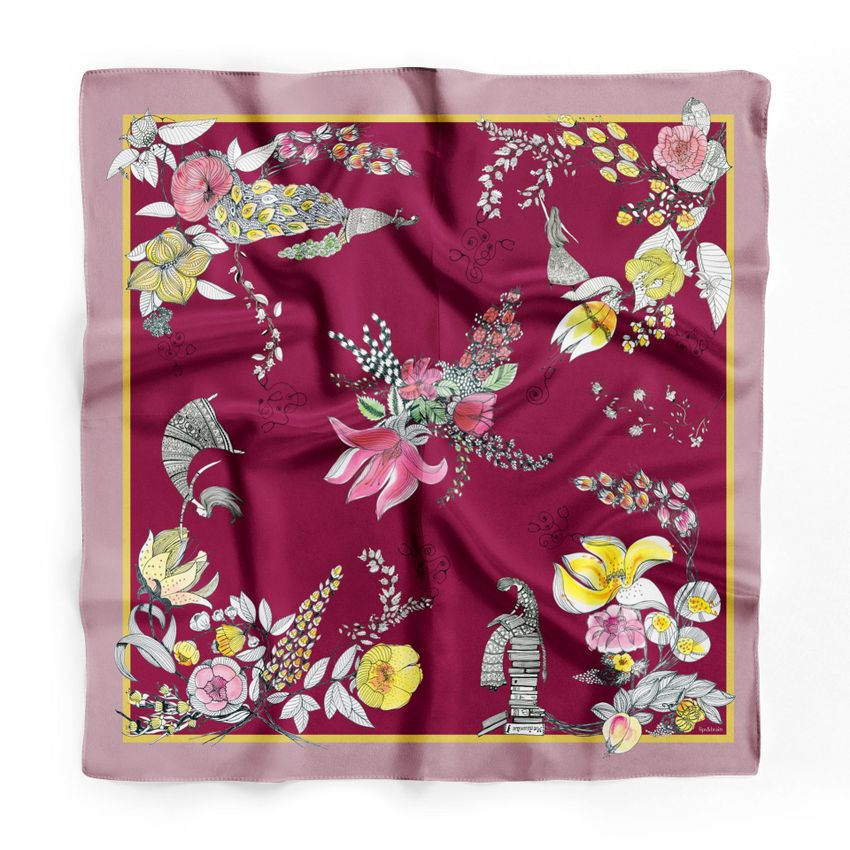 Silk scarf mockup featuring a burgundy fabric with a floral and bird pattern, bordered by a soft pink edge and yellow frame.