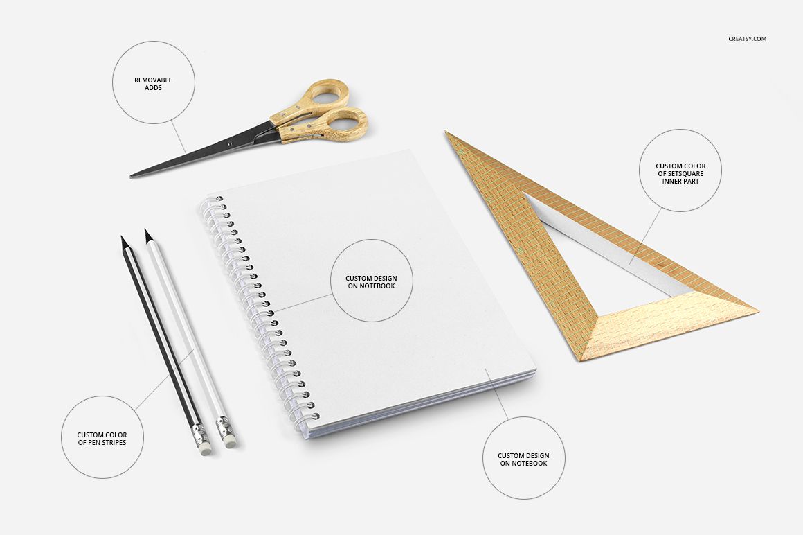 Spiral notebook mockup set with blank white cover, two pencils, scissors, and a wooden triangle on a light surface.