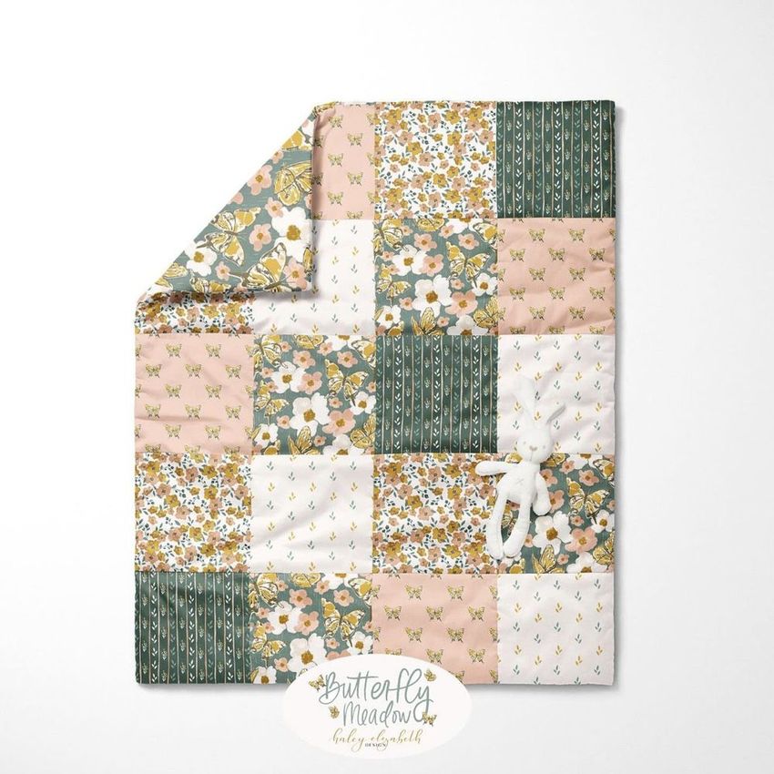 Baby patchwork quilt mockup featuring floral and geometric patterns in pastel pink, green, and white, with a plush bunny toy.