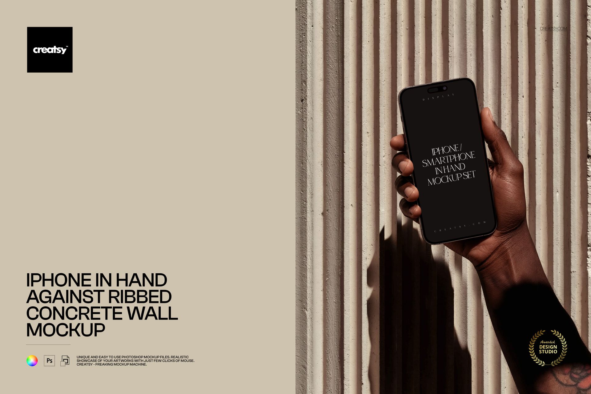 PSD mockup showing an iPhone held upright in a hand, with ribbed concrete wall and neutral lighting in the scene.