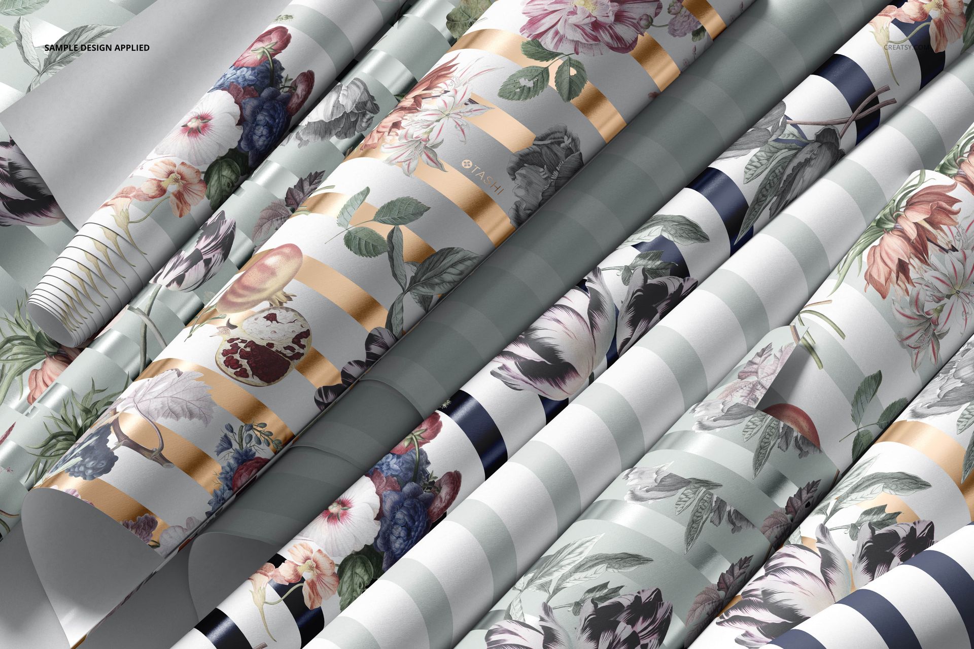 Rolled paper wallpaper mockups featuring floral patterns and metallic stripes, shown in a close-up angled view.