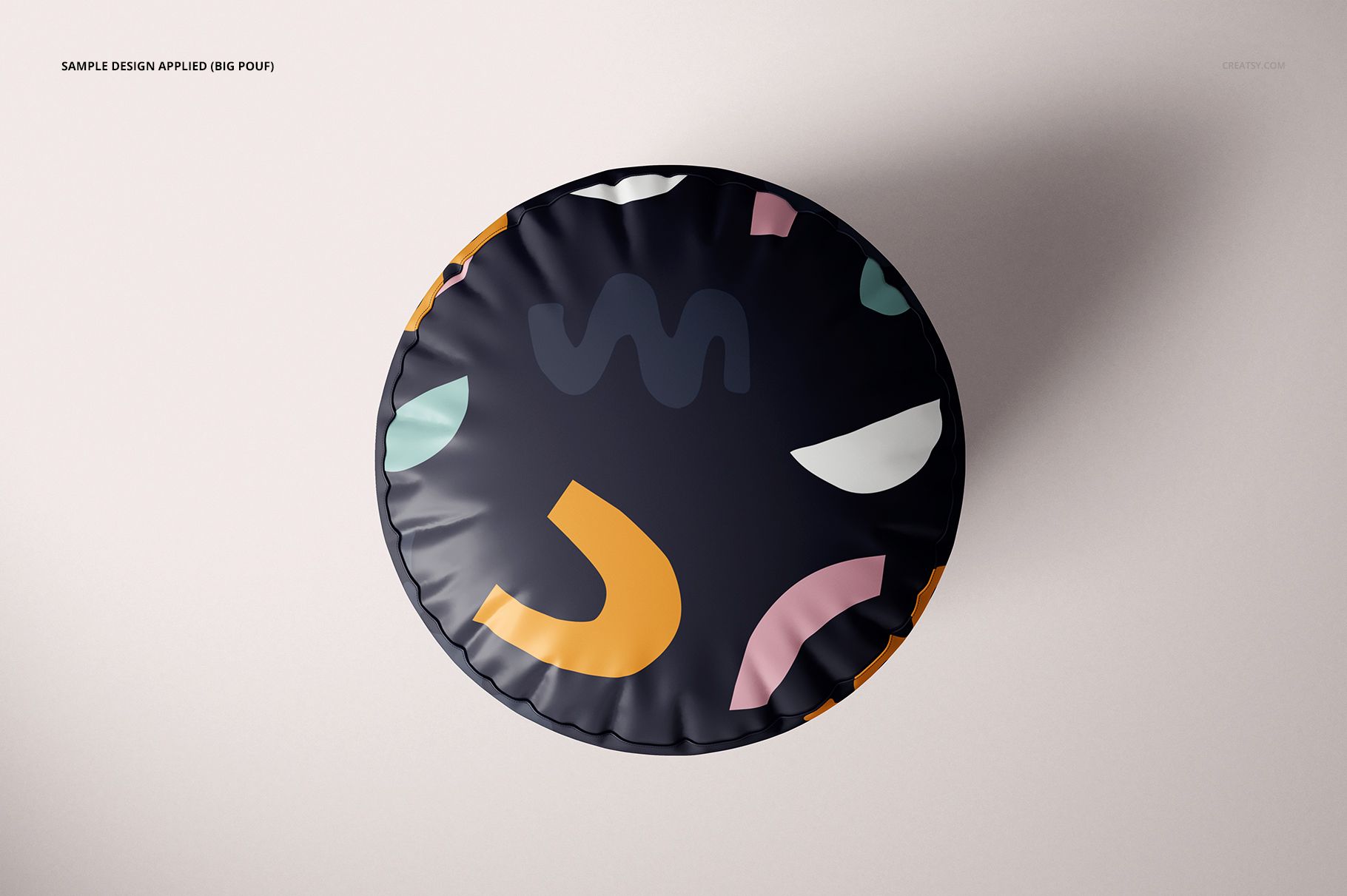 Round pouf mockup seen from above, decorated with bold geometric patterns in multiple colors on a dark background.
