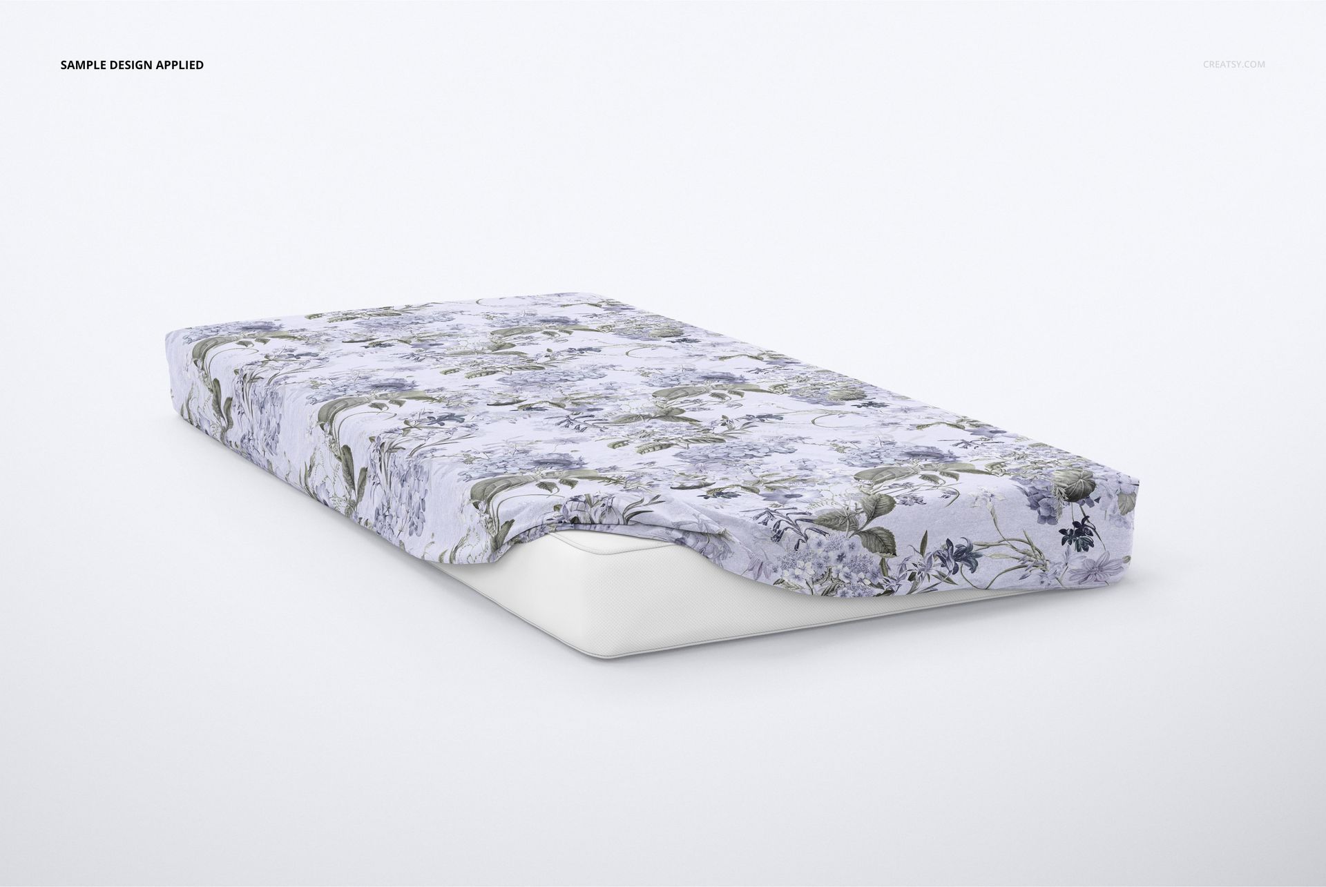 Floral brushed cotton sheet mockup displayed on a mattress, featuring blue and green tones against a plain background.