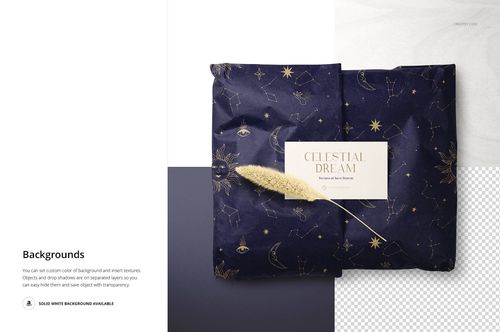Gift wrapping tissue paper mockup with navy blue and gold star designs, shown with a decorative card and dried grass.