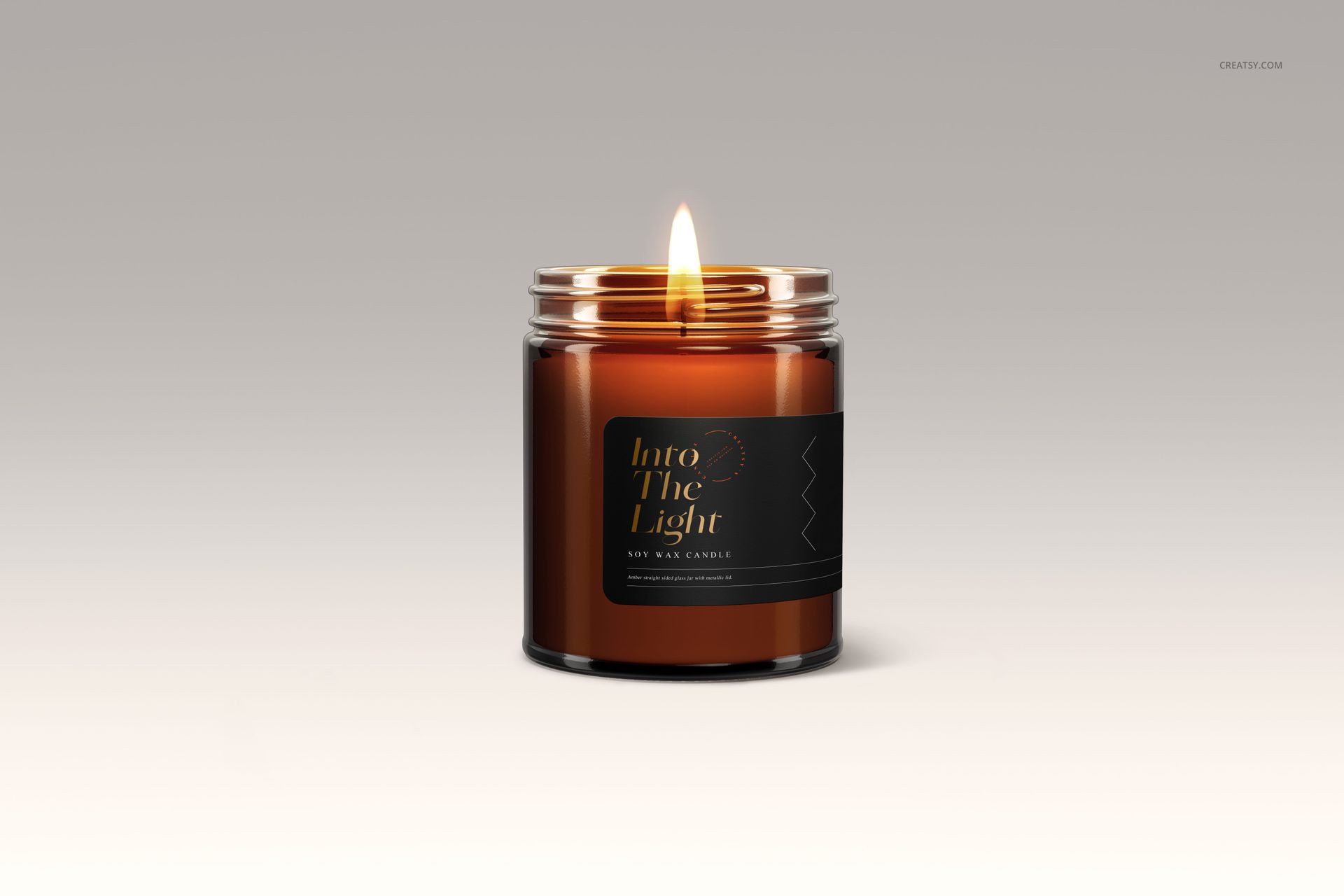 Front-facing amber jar candle mockup with a lit wick, minimalist black label, set against a soft beige backdrop.