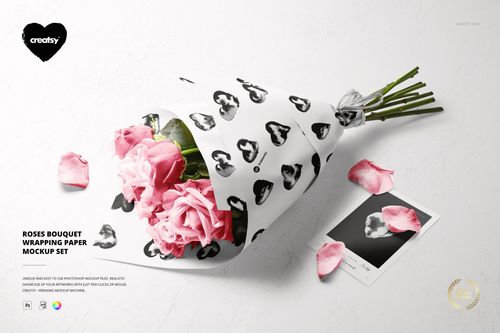 PSD mockup featuring pink roses in patterned white wrapping paper, with scattered petals and a card nearby.