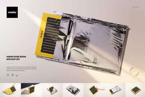 PSD mockup displaying a hardcover book with a graphic yellow cover, set on a surface with metallic foil packaging.