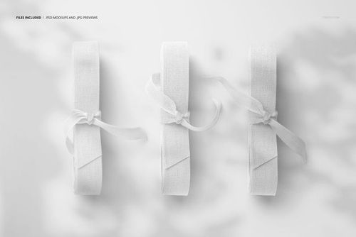 PSD mockup featuring three rolled cotton ribbons, top-down perspective, all in white with gentle shadow details.