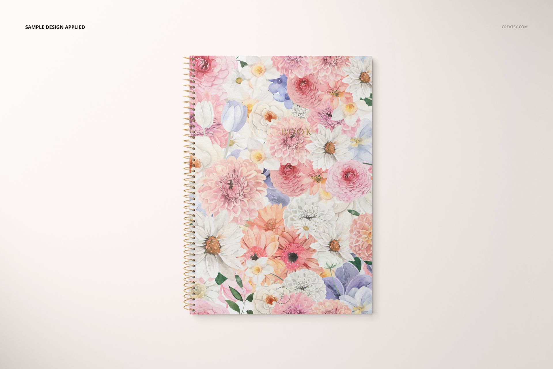 Stationery mockup featuring a spiral notebook with pastel flower pattern, shown from above on a plain surface.