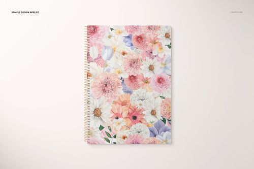 Stationery mockup featuring a spiral notebook with pastel flower pattern, shown from above on a plain surface.