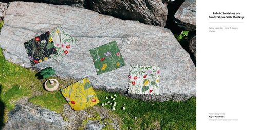 Four square fabric swatches with floral patterns displayed on a large sunlit stone slab outdoors.