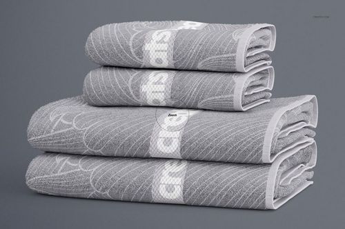 Front view of a bath towel mockup set featuring textured gray towels with white decorative elements and clean edges.