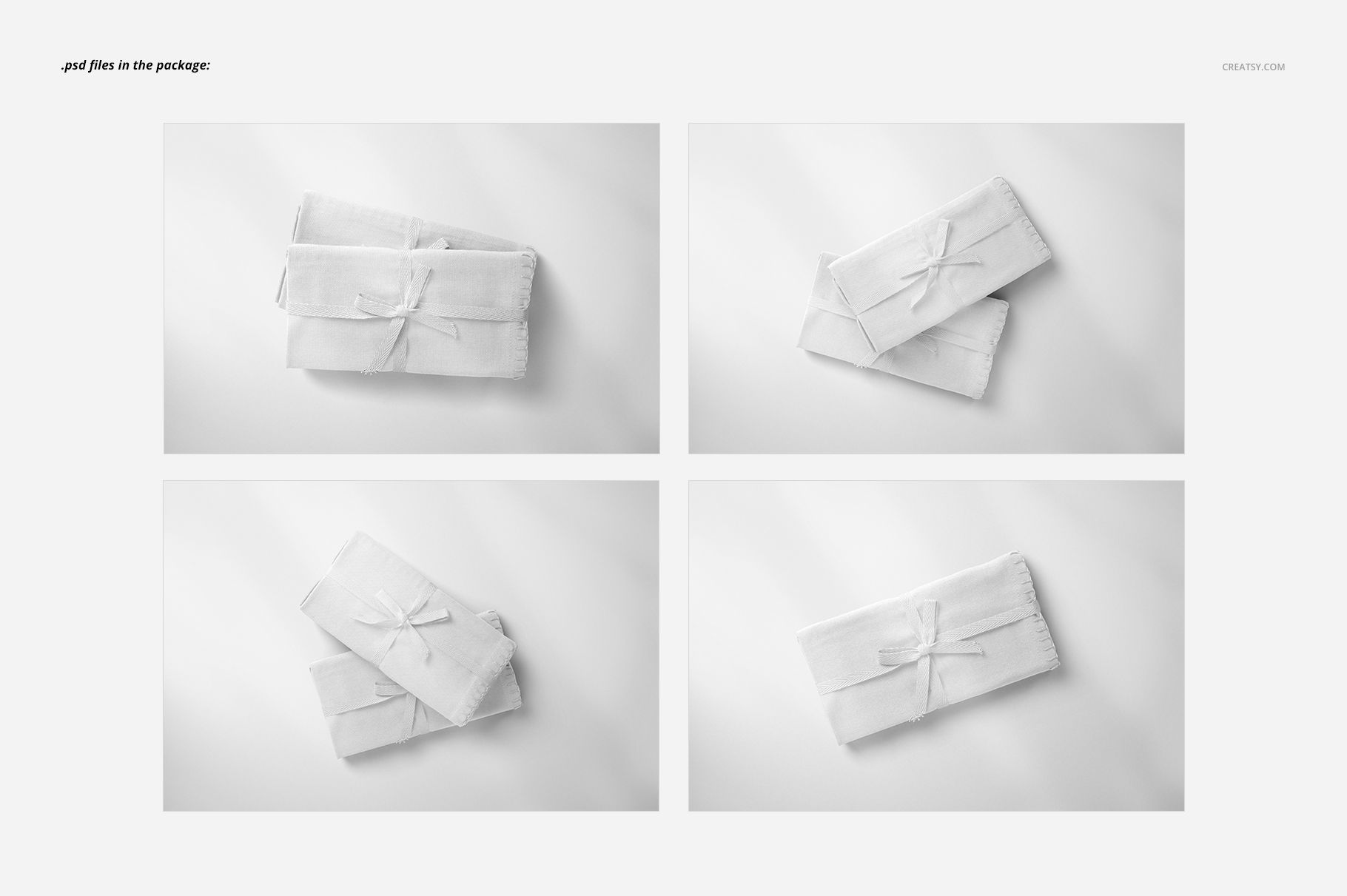 PSD mockup showing four neatly folded linen fabrics on a white surface, captured from above with subtle shadows.