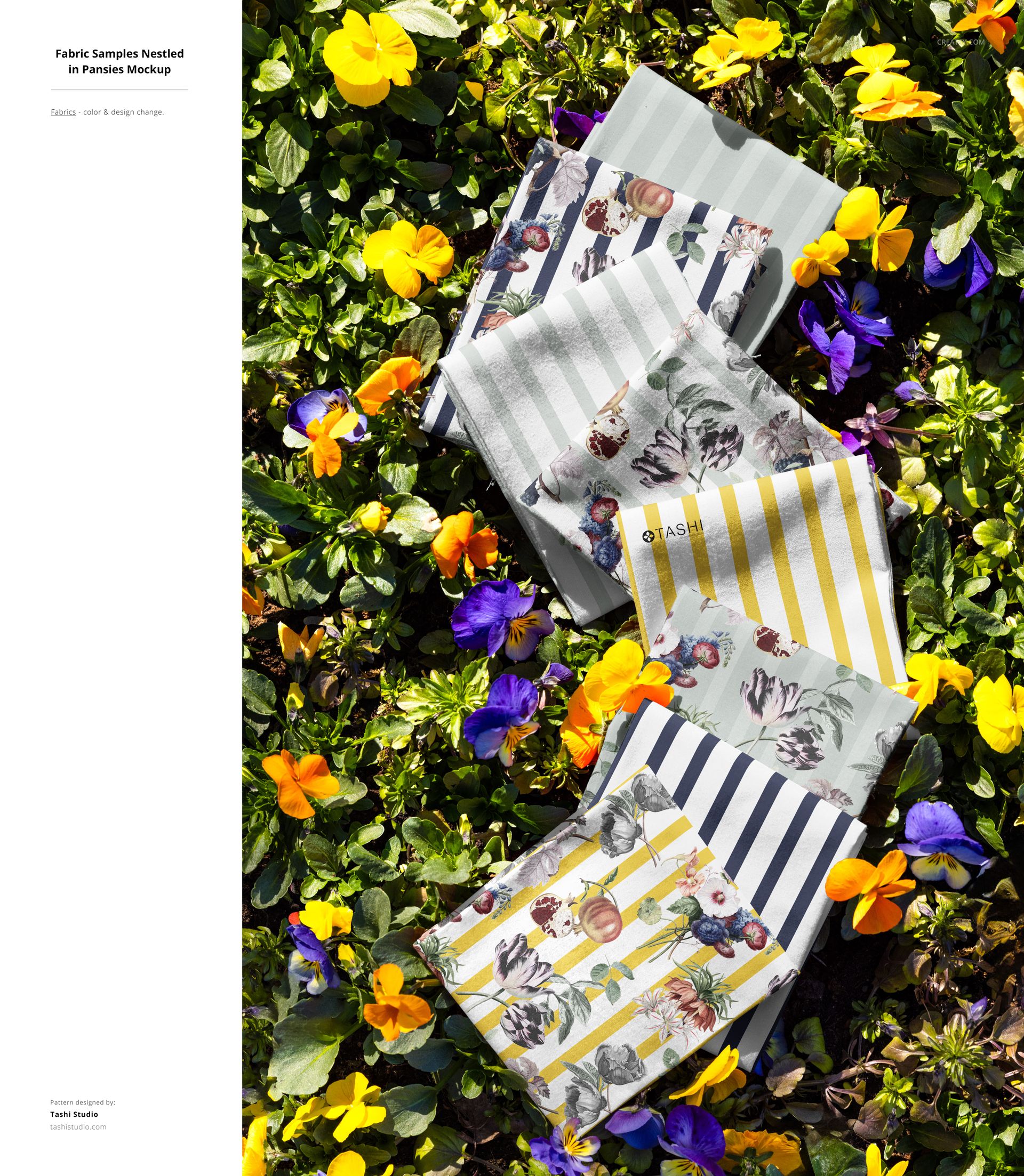 PSD mockup of patterned fabric pieces laid out on a bed of grass, surrounded by yellow and purple blossoms in sunlight.