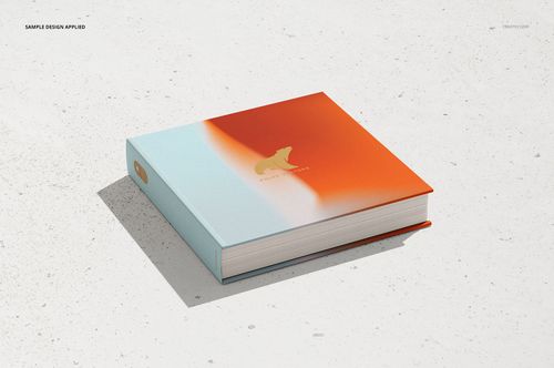 Hardcover artbook mockup with a gradient orange and light blue cover, shown in a front angled view on a white surface.