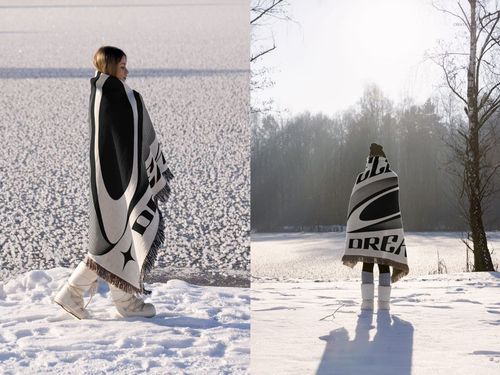 PSD mockup of a large woven blanket featuring abstract black and white design, shown in a snowy outdoor setting.