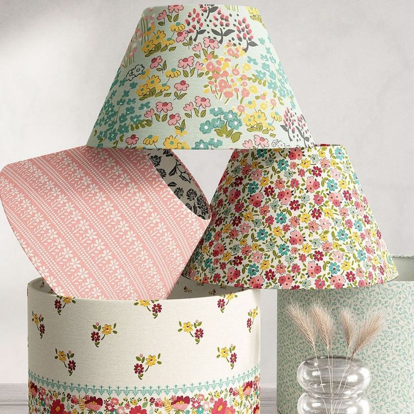Lampshade mockup featuring four lampshades with colorful floral and geometric patterns, arranged in a decorative stack on a neutral background.