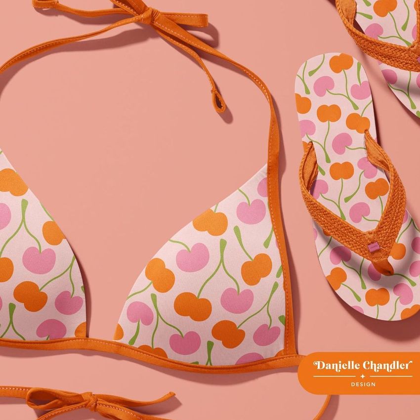 Bikini mockup set featuring a bikini top and flip-flops with a pink and orange cherry pattern on a peach background.