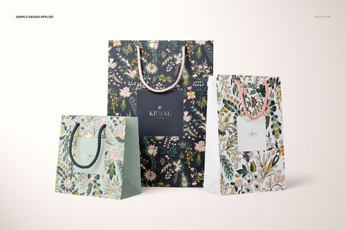 Front view of a PSD mockup featuring three patterned paper bags, each with a unique botanical design and rope handles.