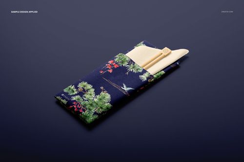 PSD mockup of chopsticks and napkin in a decorative sleeve featuring a blue base with botanical and bird motifs, top view.