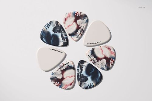 Guitar pick mockup set showing seven picks in a circular layout, with mixed marbled designs and plain white finishes.