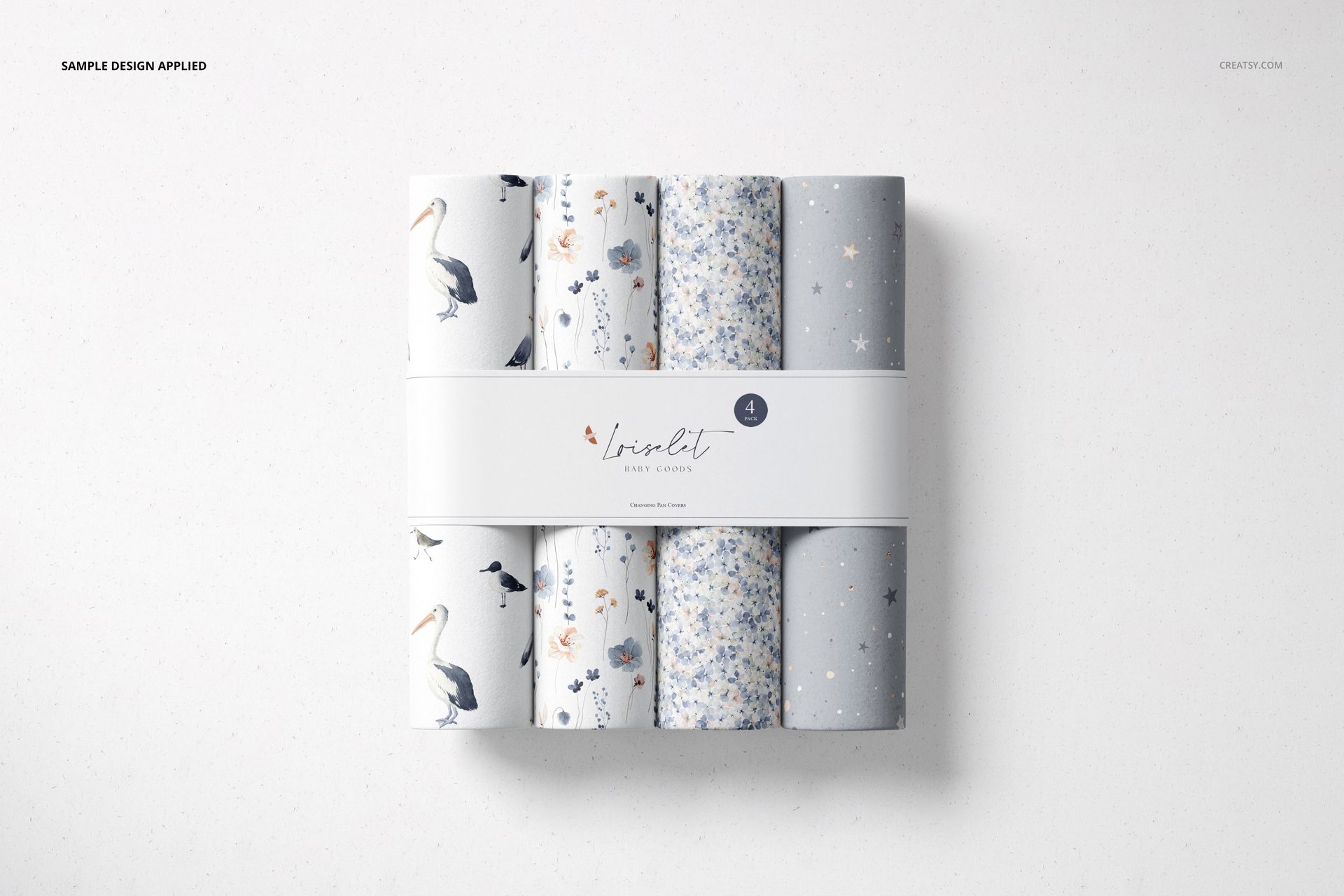 Top view of a changing pad mockup with six rolled pads in soft blue, gray, and white patterns, grouped together.