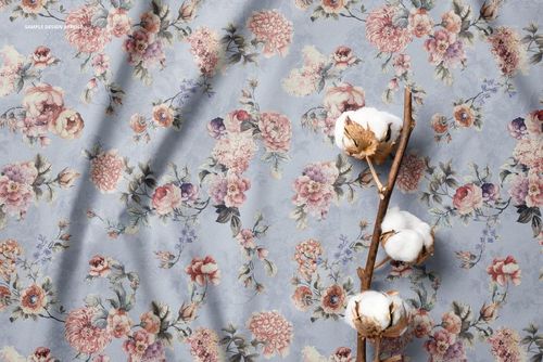 Fabric mockup featuring a cotton branch on a light blue surface with a detailed floral pattern in soft pastel colors.