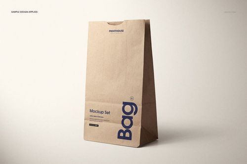 Kraft paper lunch bag mockup with simple blue text, shown from the front against a neutral background.