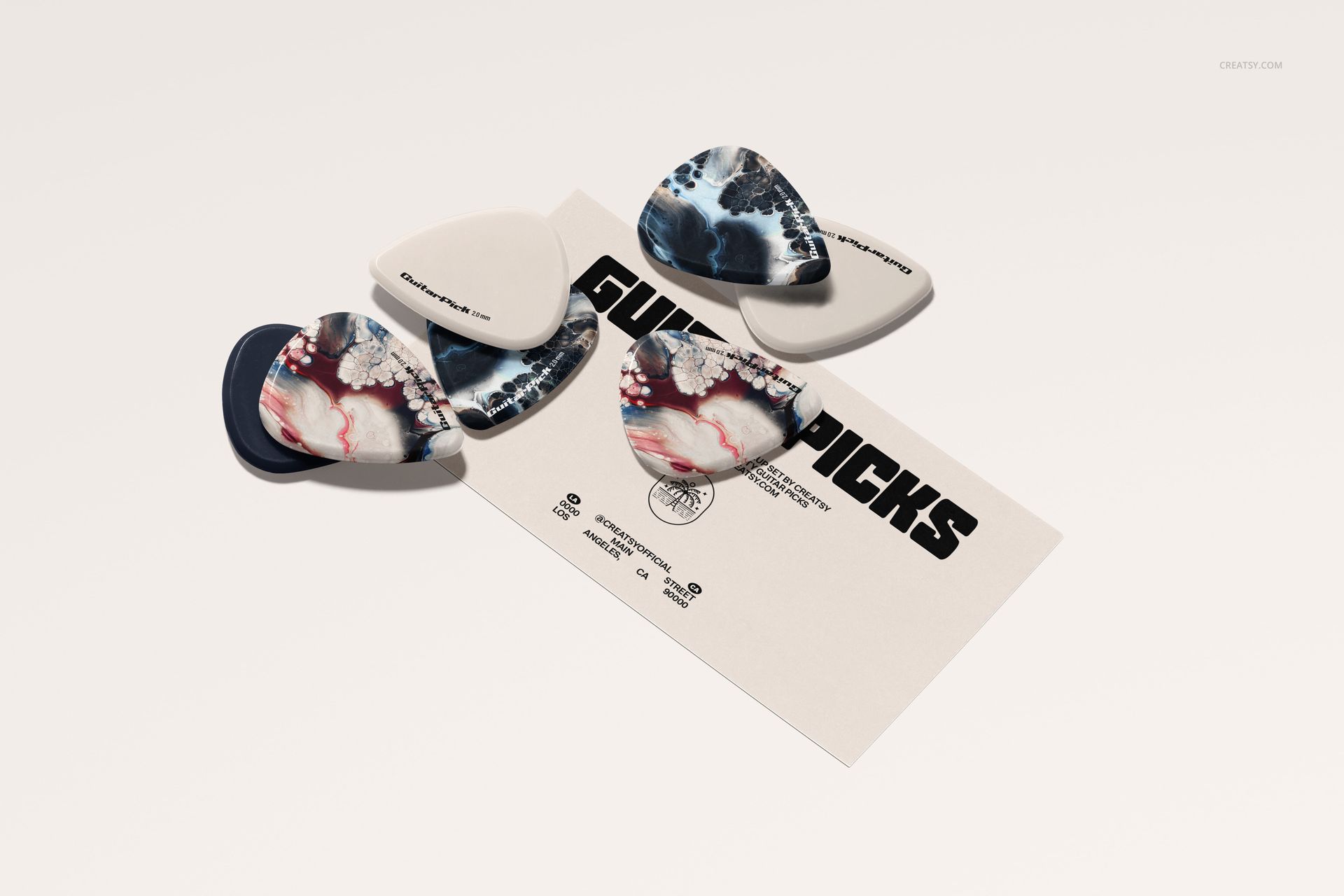 PSD mockup showing a group of colorful guitar picks with mixed patterns displayed on a flat white surface.
