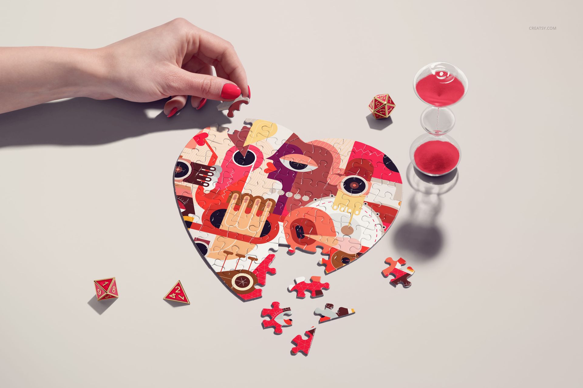 Heart jigsaw puzzle mockup with geometric artwork, loose pieces, and a hand placing a piece, seen from a bird’s-eye perspective.